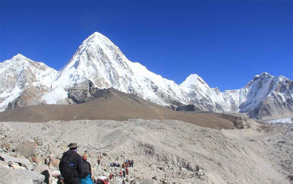 trekkers are reaching gorak shep, bright mountain views, and the blue sky on a clear day during the 10-day everest base camp trek.